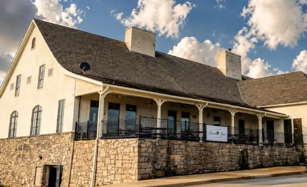Commercial building construction with stone base and covered porch