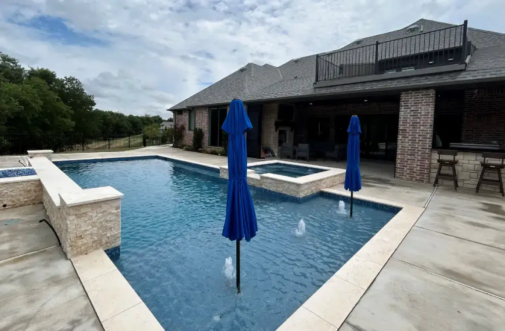 Custom home backyard with in-ground pool and covered patio
