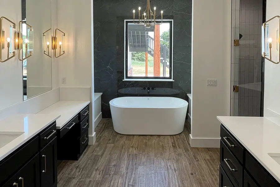 After photo of primary bathroom remodel with freestanding tub and marble accent wall - Skylar