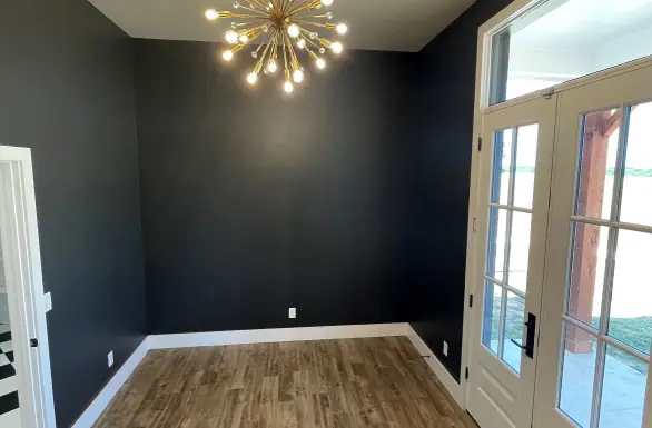 Home addition living space with dark accent wall and French doors