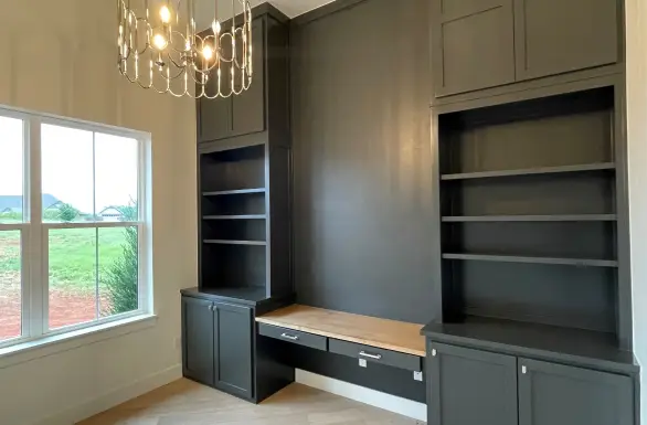 Remodeled living space with custom built-in cabinetry and shelving
