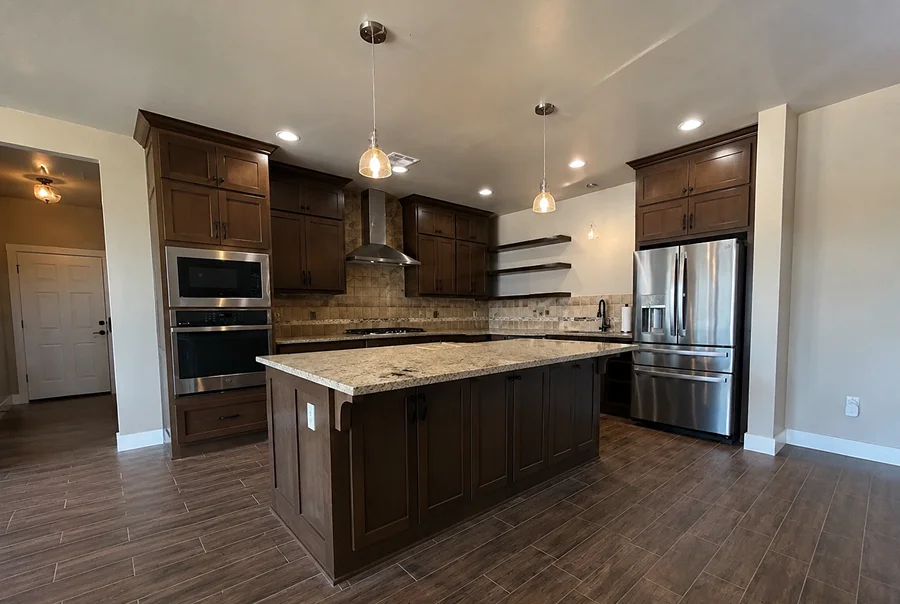 Before photo of kitchen with dark wood cabinets and granite countertops - Skylar