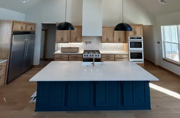 Custom kitchen remodel with navy island and white countertops